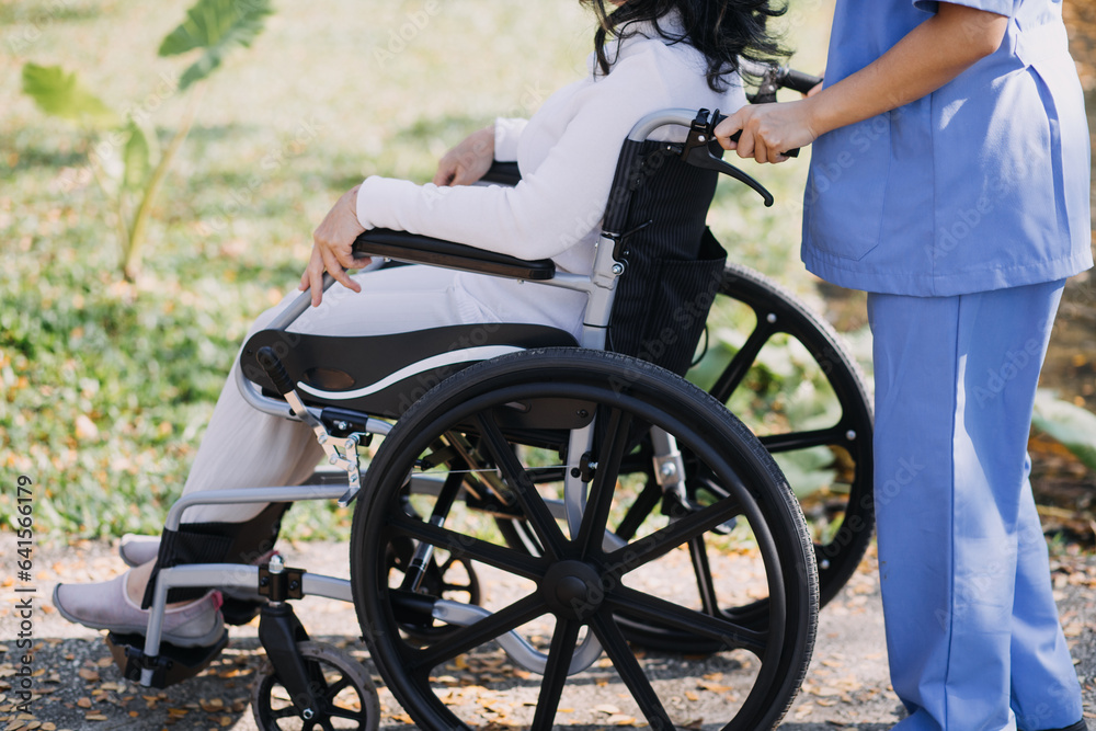 Obraz premium Asian young woman nurse at nursing home take care disabled senior man. Caregiver doctor serve physical therapy for older elderly patient to exercise and practice walking on walker or cane at backyard.