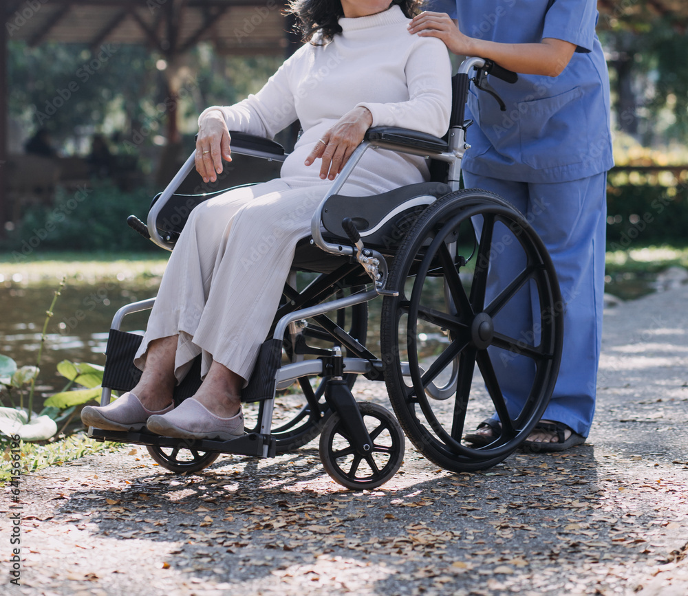 Obraz premium Asian young woman nurse at nursing home take care disabled senior man. Caregiver doctor serve physical therapy for older elderly patient to exercise and practice walking on walker or cane at backyard.