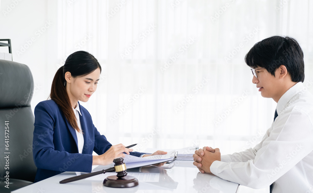 Law, Consultation, Agreement, Contract, Attorney or Lawyer holding a pen is consulting with a client to explain the pattern of answering questions before going to court to decide a lawsuit. Law, Consultation, Agreement, Contract, Attorney or Lawyer holding a pen is consulting with a client to explain the pattern of answering questions before going to court to decide a lawsuit.