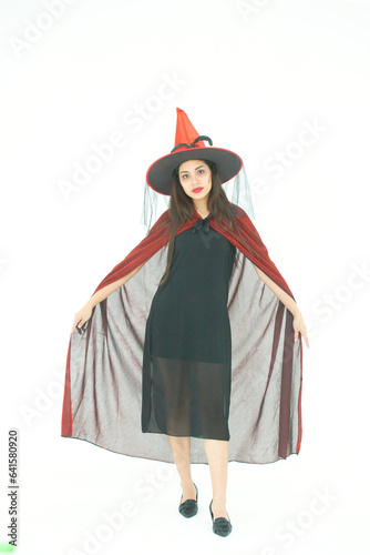 Full body Witch young lady with halloween balloon and wear witch black dress cap shoes isolated on white color background