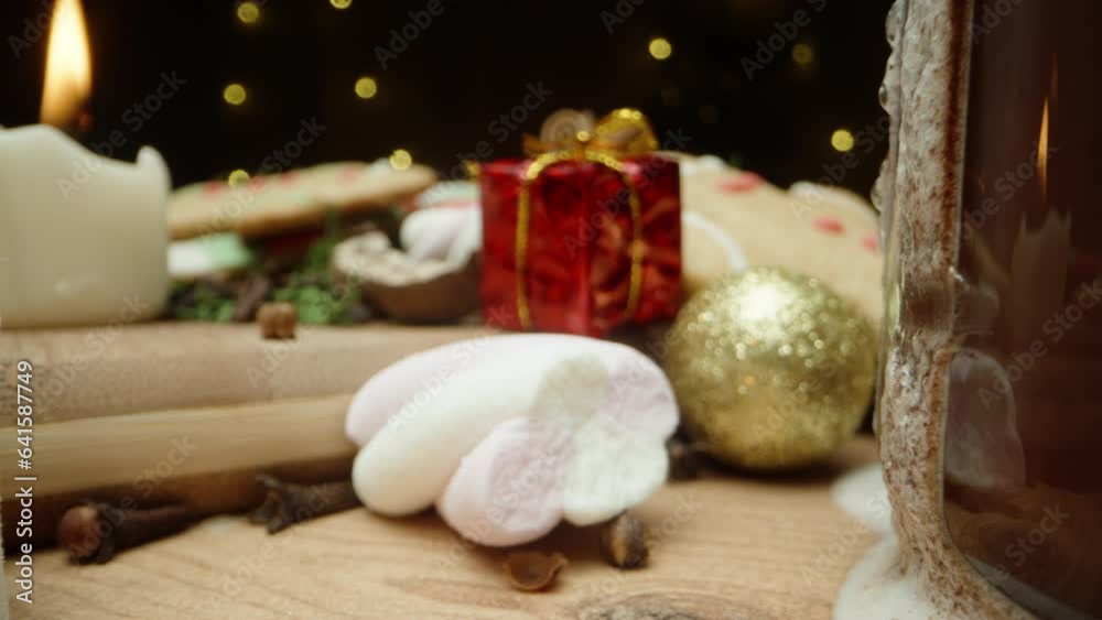 A Christmas table adorned with gingerbread cookies, marshmallows, and cocoa. Decorations and gifts are scattered everywhere. Dolly slider extreme close-up. A Christmas table adorned with gingerbread cookies, marshmallows, and cocoa. Decorations and gifts are scattered everywhere. Dolly slider extreme close-up.