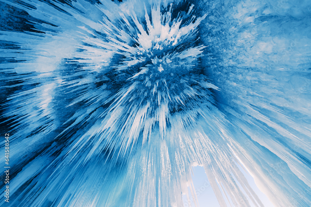 Ice cave with icicles on Baikal lake. Abstract winter nature background