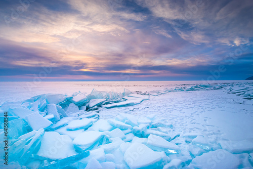 Blue ice on Baikal lake at sunrise. Khoboy cape of Olkhon island, Baikal, Siberia, Russia. photo