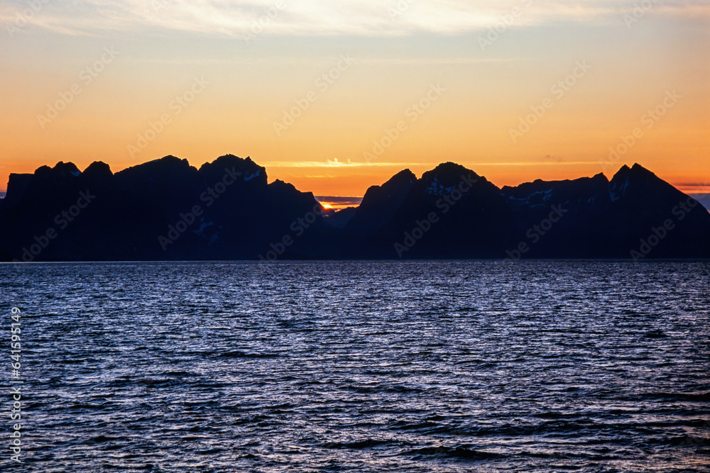 Beautiful sunset at the Lofoten Islands in Norway from the sea Beautiful sunset at the Lofoten Islands in Norway from the sea