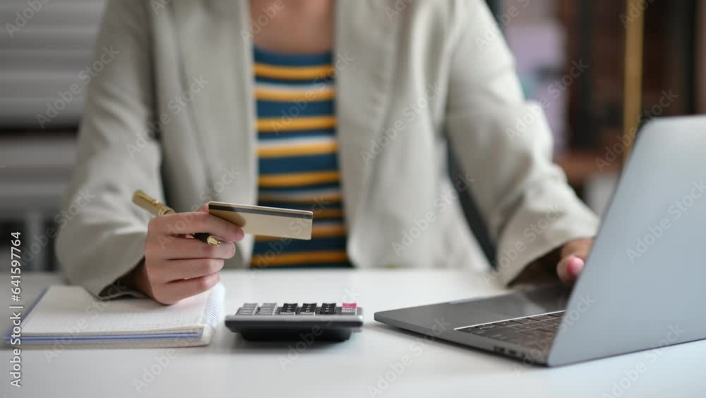 Business woman using calculator with credit card for shopping internet online and financial business strategy Business woman using calculator with credit card for shopping internet online and financial business strategy