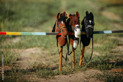 Three toys for hobbyhorsing. Toys stand on the obstacle for jumping.