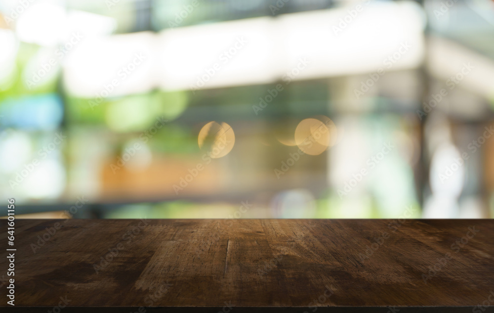 Mock up for space. Empty dark wooden table in front of abstract blurred bokeh background of restaurant . can be used for display or montage your product