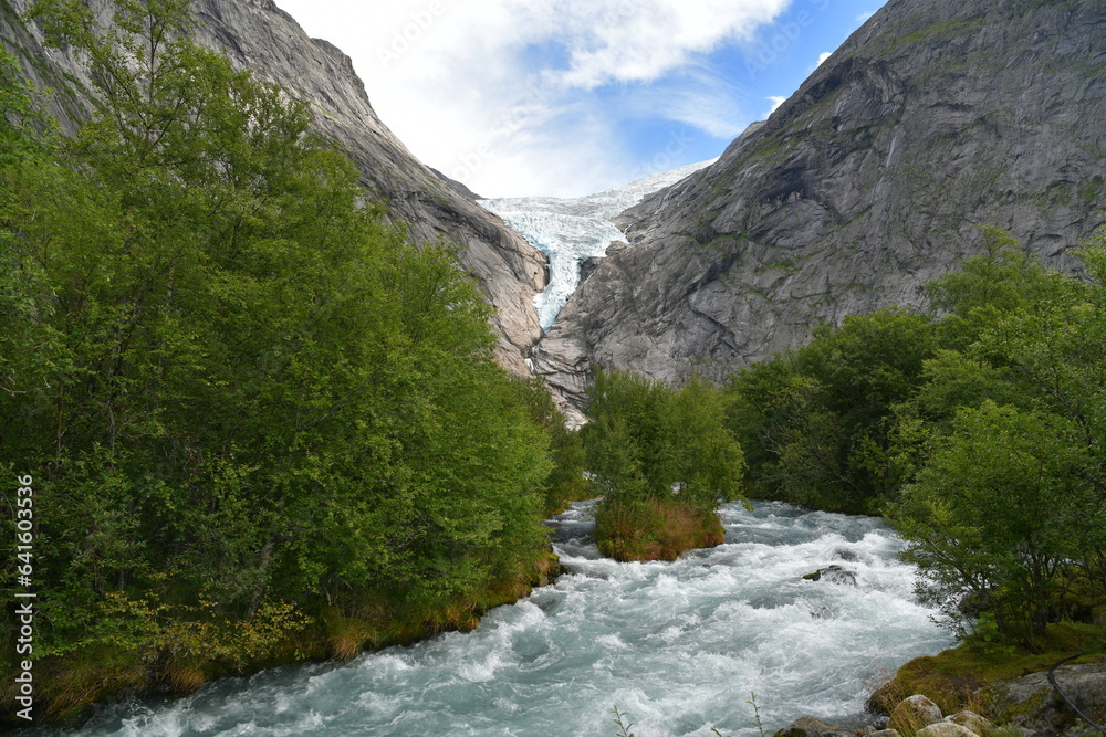 view of the glacier gorge in the background and the mountain river in the foreground view of the glacier gorge in the background and the mountain river in the foreground