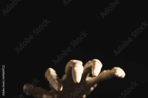Plastic skeleton hand with copy space on black background