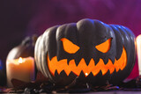 Carved umpkin and burning candle on purple background
