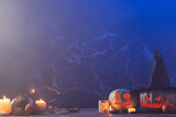 Carved pumpkins and candles with copy space on blue background