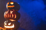 Carved pumpkins with copy space on blue background