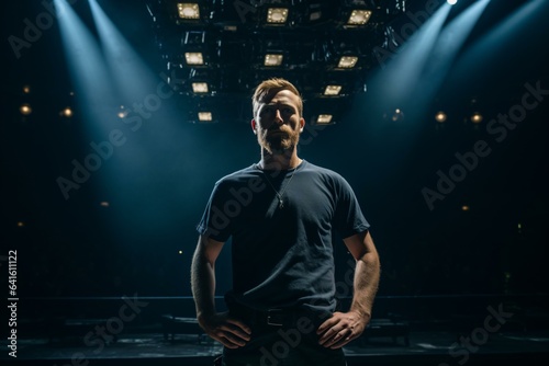 A man standing in the spotlight on a stage