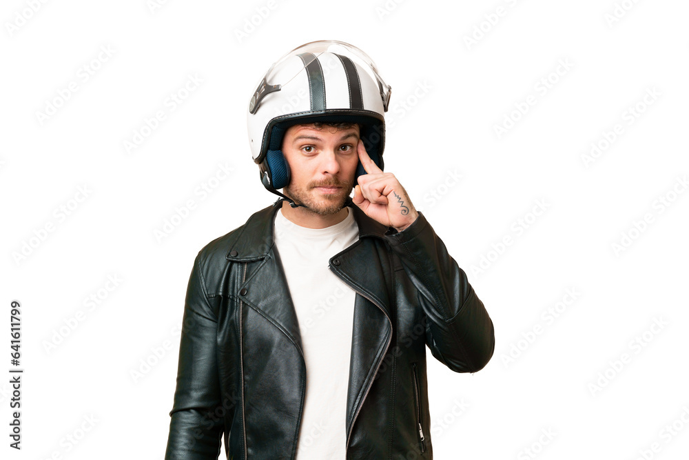 Brazilian man with a motorcycle helmet over isolated chroma key background thinking an idea Brazilian man with a motorcycle helmet over isolated chroma key background thinking an idea