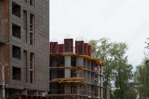Construction of new residential buildings: construction site with crane and construction equipment
