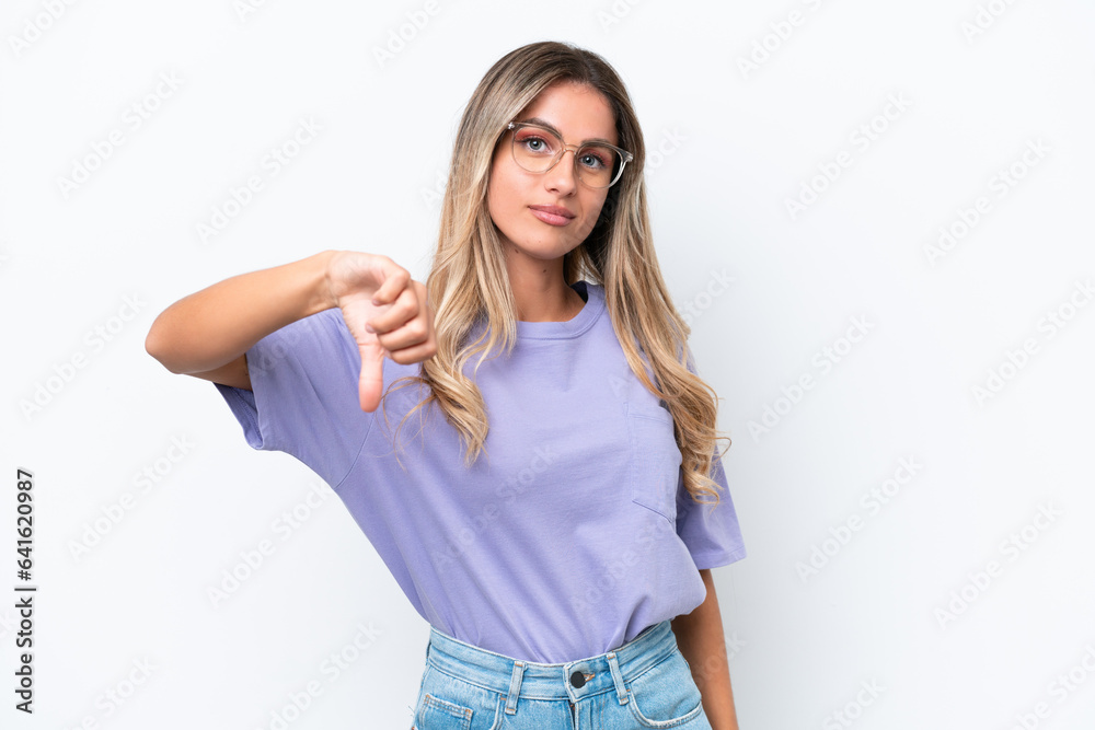 Fototapeta premium Young Uruguayan woman isolated on white background showing thumb down with negative expression