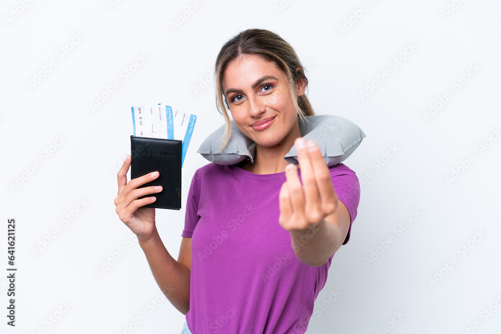Young pretty Uruguayan woman with Inflatable Travel Pillow isolated on white background making money gesture Young pretty Uruguayan woman with Inflatable Travel Pillow isolated on white background making money gesture