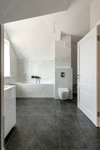 Bathroom in a modern house with black ceramic tiles on the floor