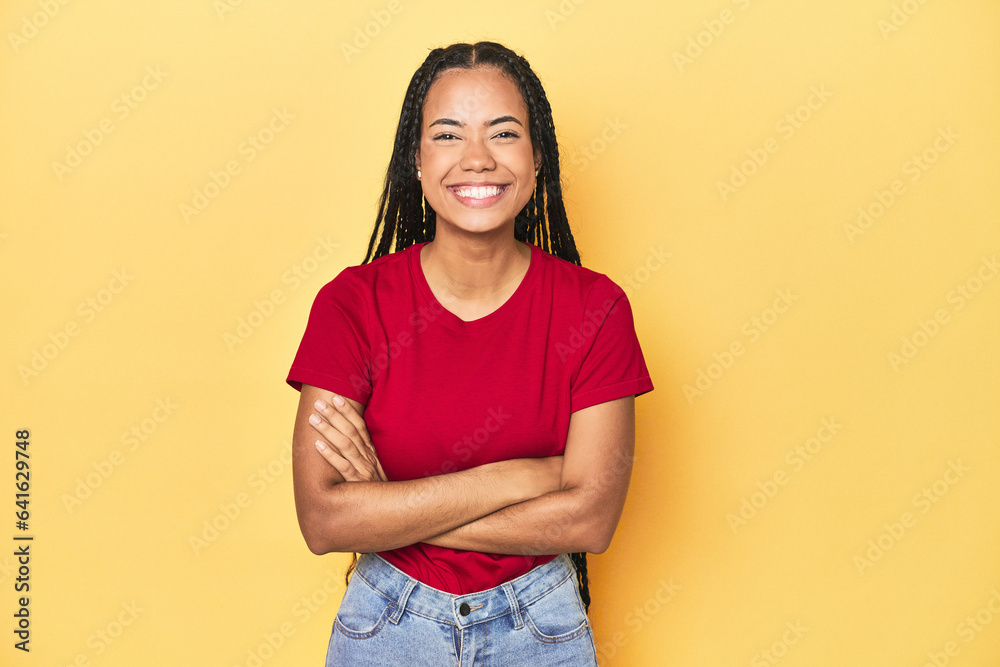 Young Indonesian woman on yellow studio backdrop laughing and having fun. Young Indonesian woman on yellow studio backdrop laughing and having fun.