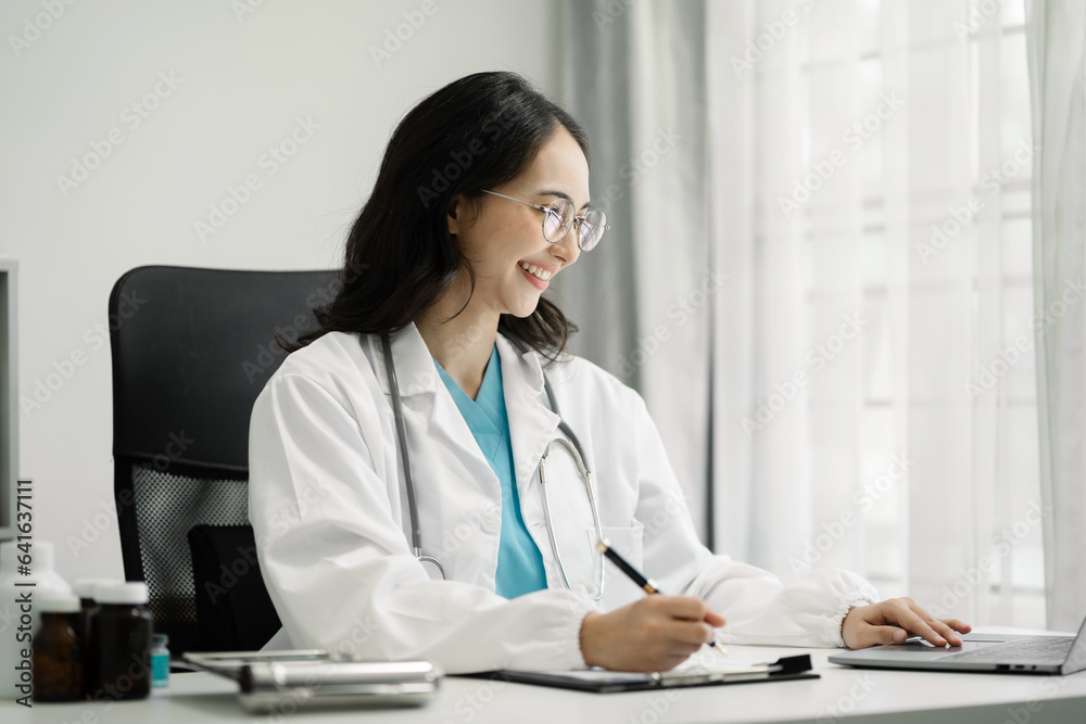 Doctor working with laptop computer and writing on paperwork. in the room. Doctor working with laptop computer and writing on paperwork. in the room.