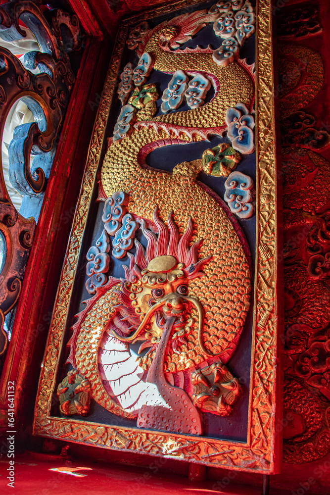 Carved shutters in an oriental temple. Richly decorated shutters with dragon theme, Chinese Buddhist monastery, Wat Phanan Choeng Worawihan, Ayutthaya Thailand..