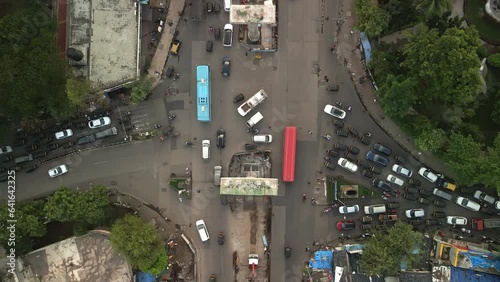 Aerial view from above of cars, motorcycles, bus, trucks at crossroads in Chembur, suburban Mumbai. Aerial topdown of Indian road traffic