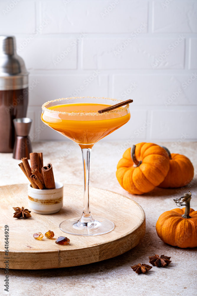 Halloween, Thanksgiving or fall cocktail pumpkin martini, homemade festive seasonal drink pumpkintini with cinnamon
