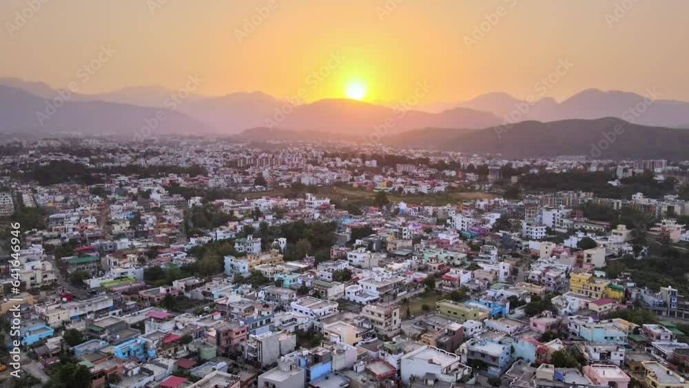 Beautiful landscape at sunrise through mountain top with houses and rooftops in Dehradun. Sunrise in Dehradun.