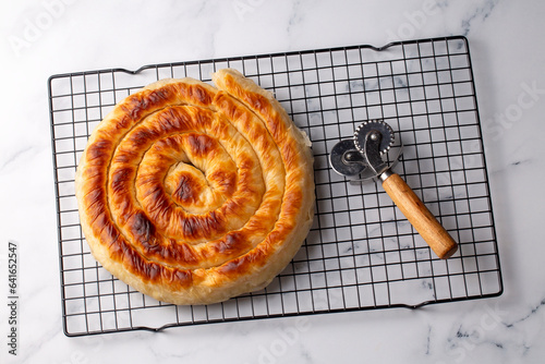 Turkish Tepsi Boregi, Round Borek, Tray pastry (Turkish name; rulo borek - ispanakli borek) photo