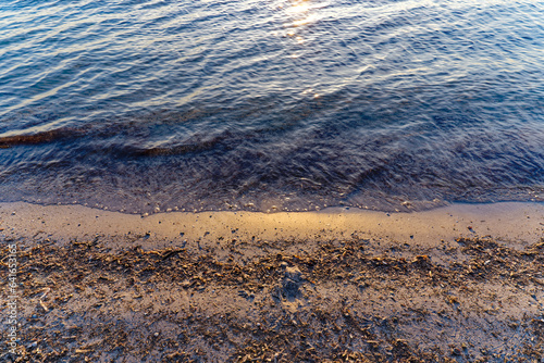 Close-up top view of sandy beach with evening sunlight at Giens peninsula on a sunny spring day. Photo taken June 8th  2023  Giens  Hy  res  France.