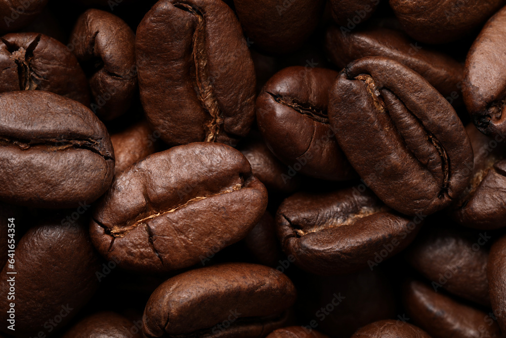 Naklejka premium Aromatic roasted coffee beans as background, closeup