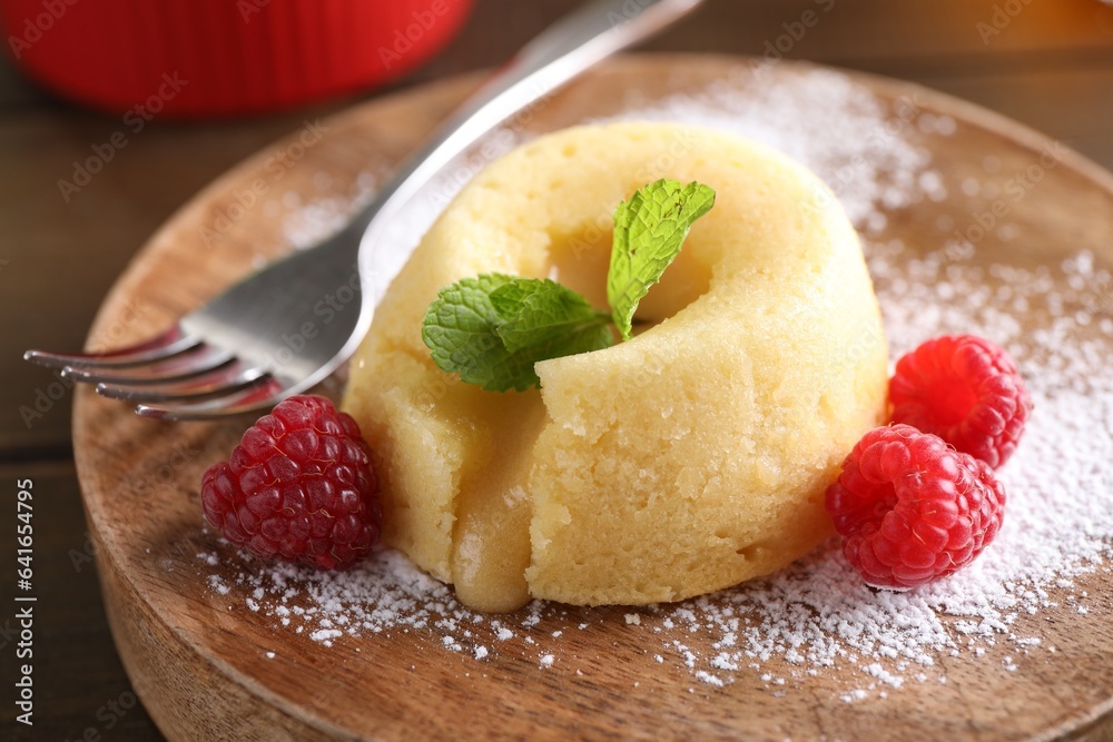 Tasty vanilla fondant with white chocolate and raspberries on table, closeup Tasty vanilla fondant with white chocolate and raspberries on table, closeup