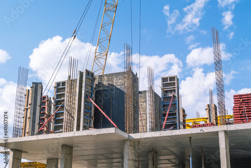 The foundation on reinforced concrete piles and the frame during the construction of a multi-storey building. Reinforcement of reinforced concrete columns. Construction of high-rise buildings.