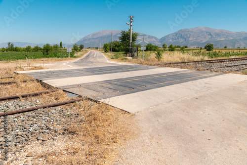 Unguarded, light rail railway crossing without barriers and warning lights photo