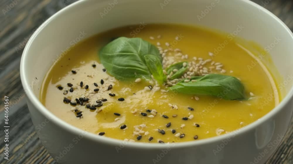 Sesame seeds sprinkled on pumpkin soup puree Sesame seeds sprinkled on pumpkin soup puree