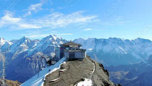 flying Schilthorn piz Gloria: fantastic shot over the station and overlooking spectacular snow-capped mountains and in a Swiss autumn landscape.