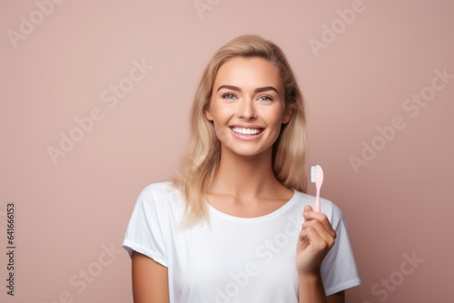 Lifestyle portrait photography of a satisfied girl in her 20s brushing her teeth with a toothbrush against a pastel or soft colors background. With generative AI technology