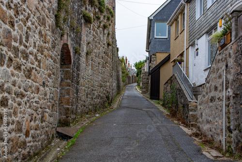 Narrow street with traditional stone houses in a coastal town of St Ives  Cornwall  United Kingdom .