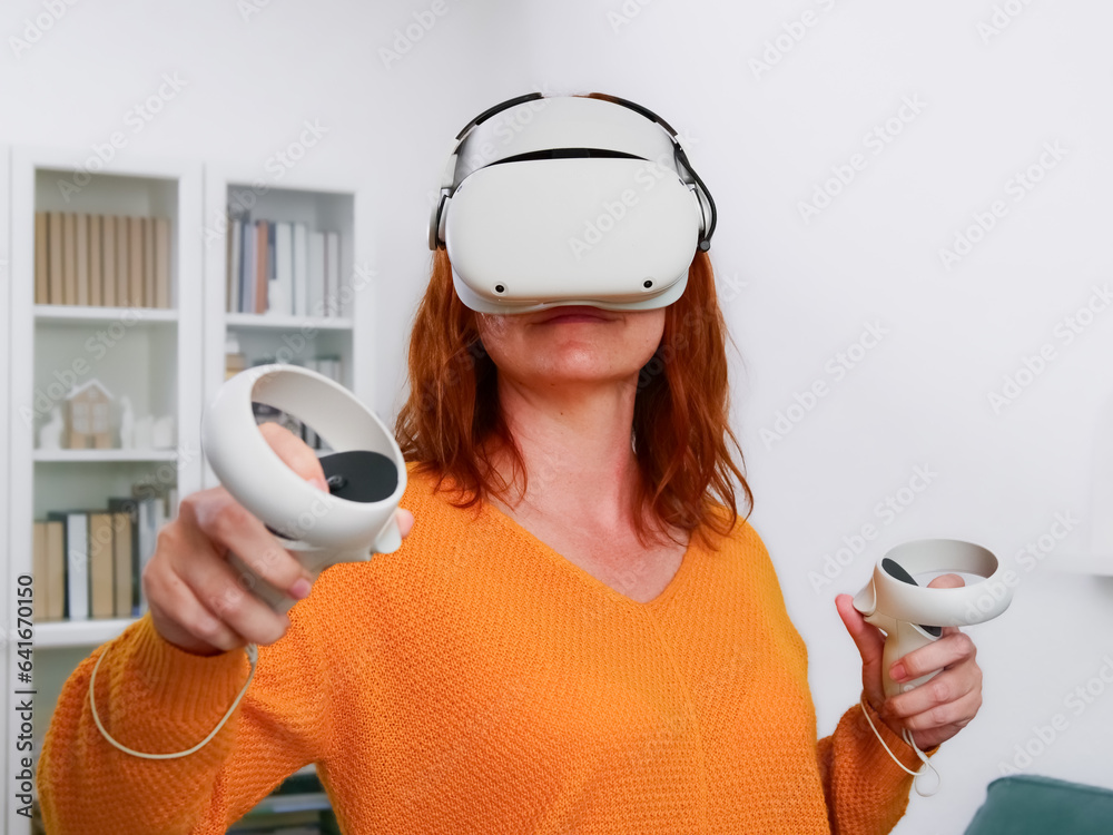 The man relaxing and playing VR goggles and using futuristic tablet at home. the concept of metaverse, versual reality, future, technology, and internet of things.