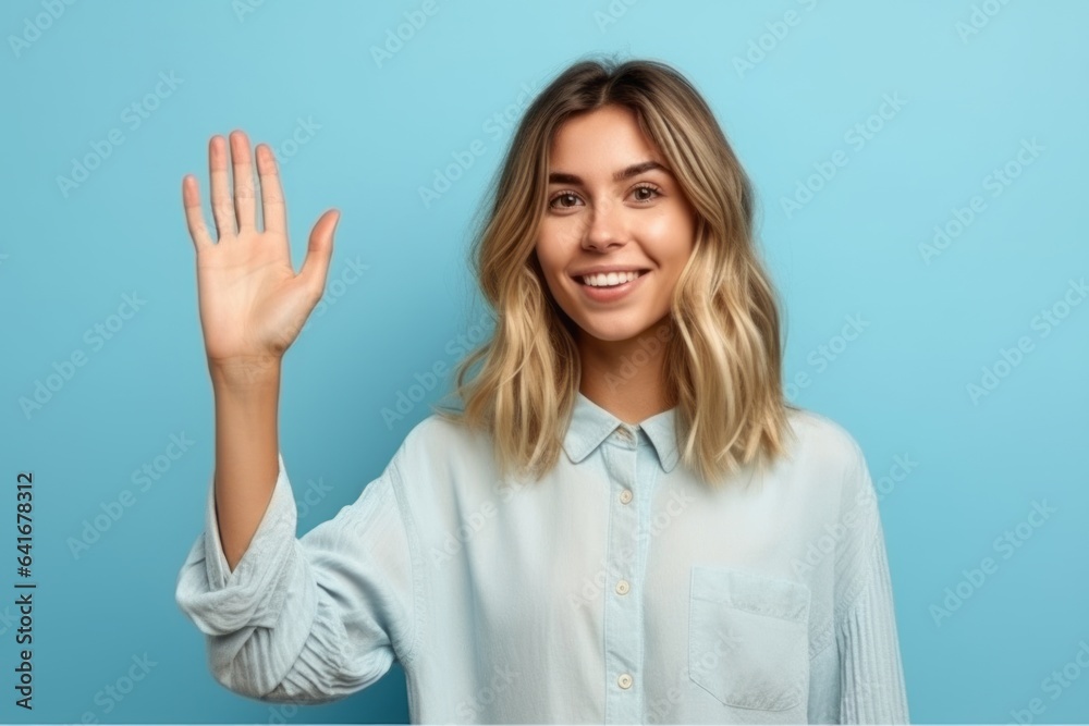 Medium shot portrait photography of a glad girl in her 20s making a no or stop gesture with the extended palm against a soft blue background. With generative AI technology Medium shot portrait photography of a glad girl in her 20s making a no or stop gesture with the extended palm against a soft blue background. With generative AI technology
