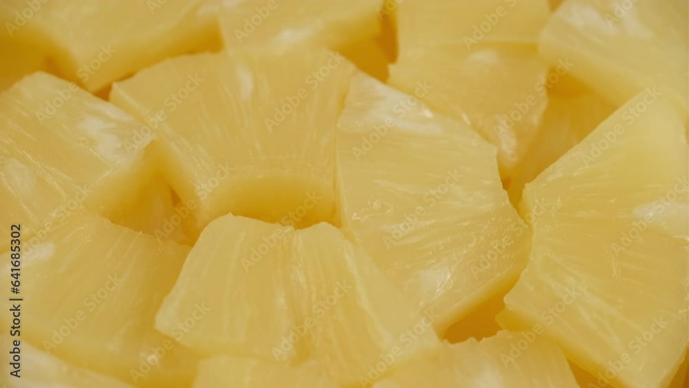 Chopped canned pineapple close up, rotation Chopped canned pineapple close up, rotation