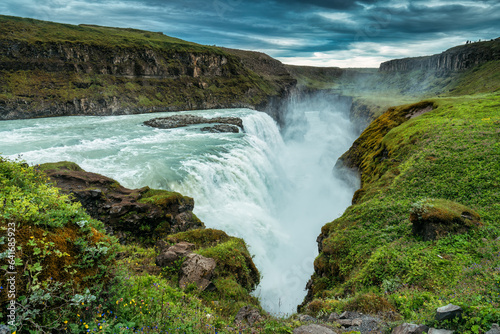 Gullfoss powerful waterfall flowing from Hvita river and moody sky in summer at Iceland