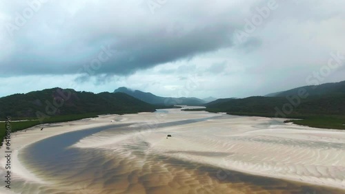 Hill Inlet On Whitsunday Island, Queensland, Australia; Slow Aerial Flight Showcasing The White Sweeping Sand. photo