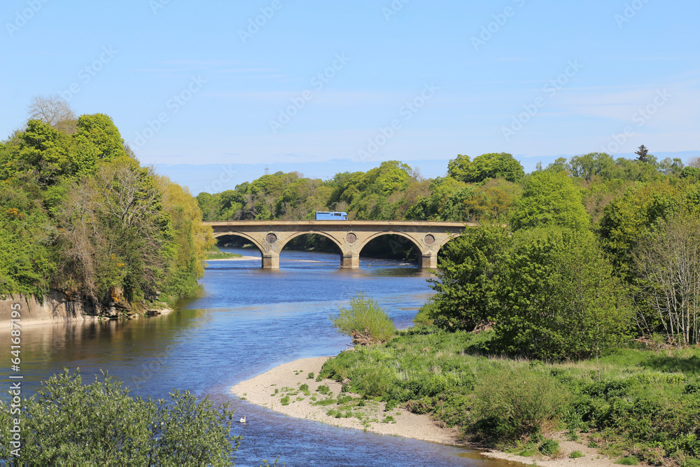 A bright sunny view in spring across the River Tweed from Scotland towards England.
