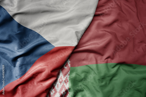 big waving national colorful flag of czech republic and national flag of belarus .