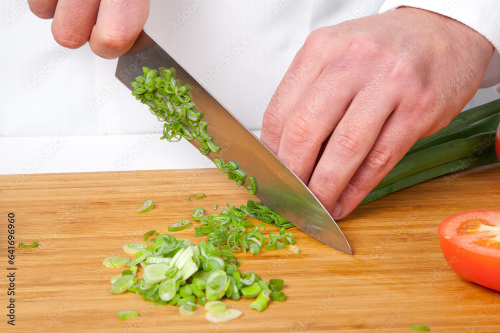 Talented Chef Meticulously Slicing Fresh Green Onions in a Spacious Kitchen: A Captivating Display of Culinary Skill and Artistry Talented Chef Meticulously Slicing Fresh Green Onions in a Spacious Kitchen: A Captivating Display of Culinary Skill and Artistry