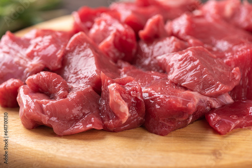 Soft focus on raw sliced beef or lamb meat.