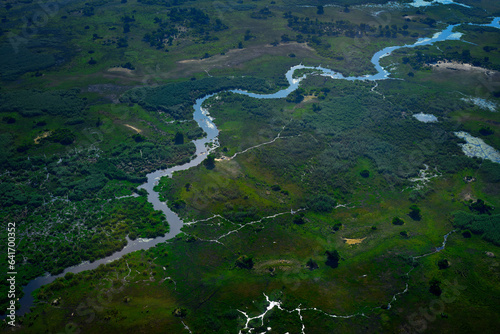 Green vegetation in South Africa. Trees with water in rainy season. Blue river, Aerial landscape in Okavango delta, Botswana. Lakes and rivers, view from airplane. © ondrejprosicky