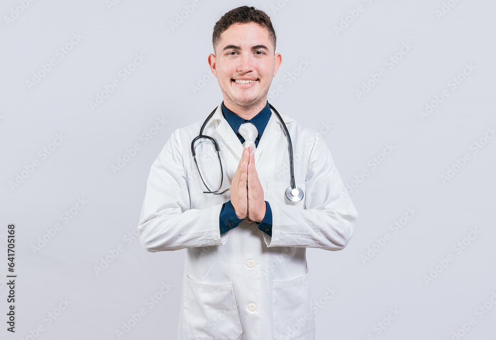 Smiling latin doctor with palms together isolated. Cheerful doctor putting palms together. Handsome doctor with hands together isolated Smiling latin doctor with palms together isolated. Cheerful doctor putting palms together. Handsome doctor with hands together isolated