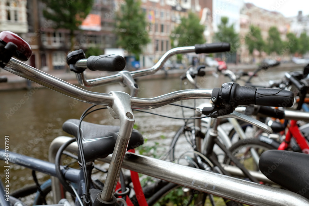 Row of bicycles in Amsterdam, Netherlands, next to the water Row of bicycles in Amsterdam, Netherlands, next to the water
